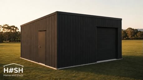 Black corrugated steel shed with roller door at golden hour